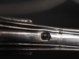 close up of a metal object with a small hole in the middle of it