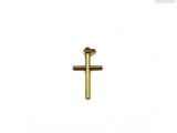 a gold cross on a white surface with a white background