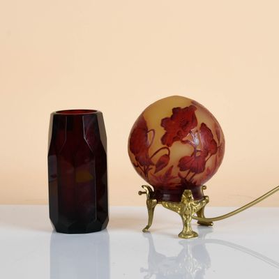 a red vase and a brown vase sitting on a table