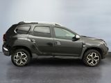 the front view of a grey dacia parked on a gray floor
