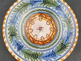 a plate with a design on it sitting on a table