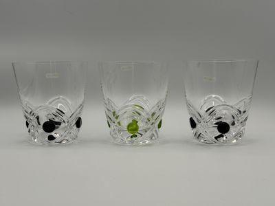 three shot glasses with black and white designs on them