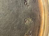 a close up of a silver plate with holes in it