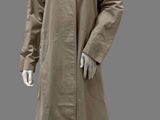 an image of a mannequin dressed in a beige trench coat