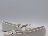 a close up of a pair of white shoes on a white surface