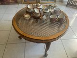 a table that has a lot of cups and saucers on it