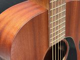 a close up of a wooden guitar with a black background