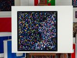 a picture of a painting on a easel in a room