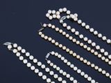 a close up of a white pearl necklace and a pair of earrings