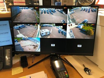 a desk with a computer monitor and a cell phone on it