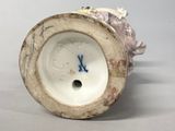 a white vase with a blue and white design on it