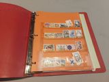 a red binder with stamps on it on a table