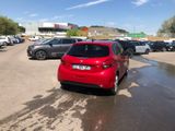 a red car that is parked in a parking lot