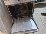 a silver oven that is sitting on a tiled floor