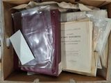 a box full of books and papers sitting on a table