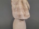the back of a mannequin head with a fur coat on it