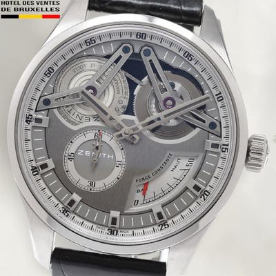a close up of a watch with a black leather strap