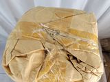 a bag of food wrapped in plastic sitting on top of a bed