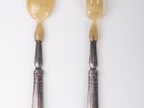 three spoons and a fork on a white table