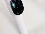 a white electronic device sitting on a table next to other electronic devices