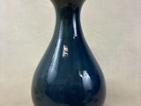 un vase bleu posé sur une table
