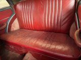 a red leather seat in the back of a red car