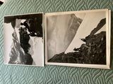 two black and white photos hanging on the wall above a bed