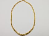 a gold rope necklace on a white background