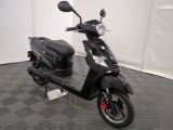 a black scooter parked in a garage