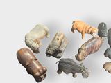 many different types of animal figurines on a white surface