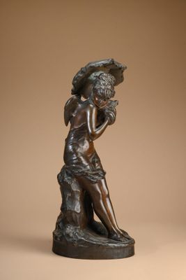 bronze statue of a woman with an umbrella on a pedestal