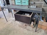 a desk with a drawer underneath it in a garage