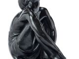 sculpture of a woman sitting on her knees with her hand on her chin
