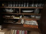 a wooden cabinet with a lot of dishes and glasses on it