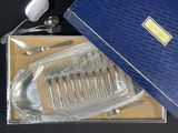 a blue box with silverware in it on a table