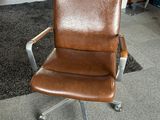brown leather office chair with chrome base and casteors