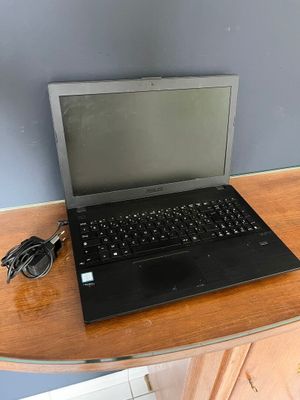 a laptop computer sitting on top of a wooden desk