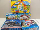 quatre boîtes de Playmobil et une boîte de jouets