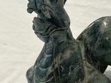 a statue of a dog that is sitting on the ground