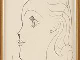 a drawing of a woman ' s face in a gold frame
