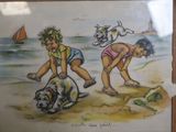 two children and a dog on the beach playing in the sand