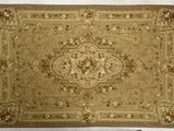 beige area rug with a floral design on a white background
