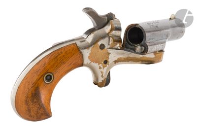 an old revolver with a wooden handle on a white background