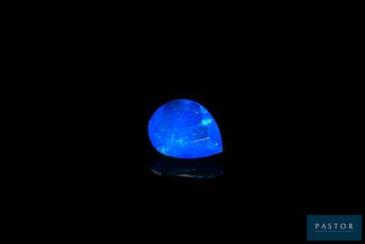 a blue light in the dark with a black background