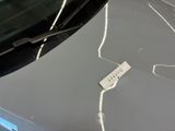 a sticker on the windshield of a car that has been smashed