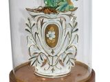 a vase with flowers inside of it on a wooden stand
