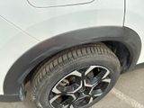 a close up of a tire on a white car