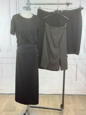 two dresses hanging on a clothes rack in a room