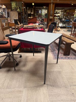 a table and chair in a room with a lot of furniture