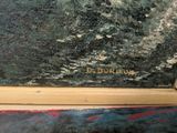 a picture of a painting on a table with a wooden frame